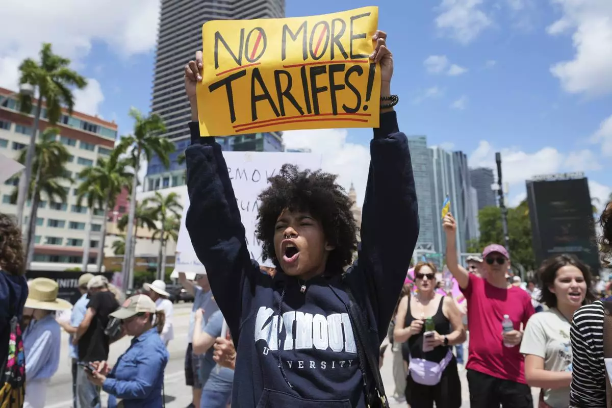 Paul Ivanov chants slogans during a protest against the Trump administration, Saturday, April 19, 2025, in Miami. (AP Photo/Lynne Sladky)
