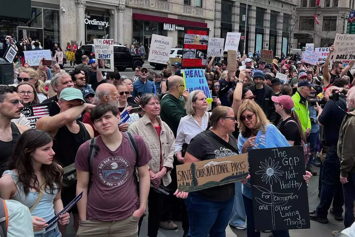 People gather to protest President Donald Trump's policies on Saturday, April 19, 2025 in New York. (AP Photo/Joseph Frederick)