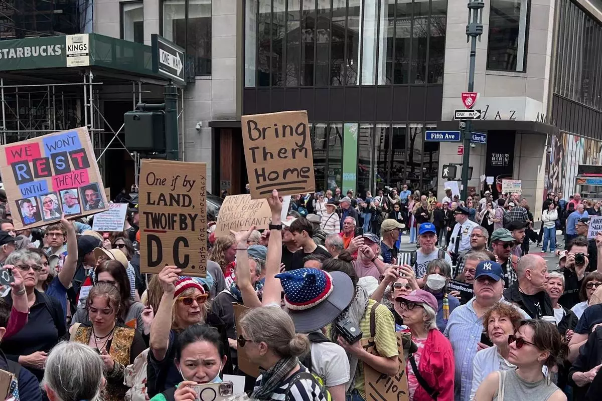 People gather to protest President Donald Trump's policies on Saturday, April 19, 2025 in New York. (AP Photo/Joseph Frederick)