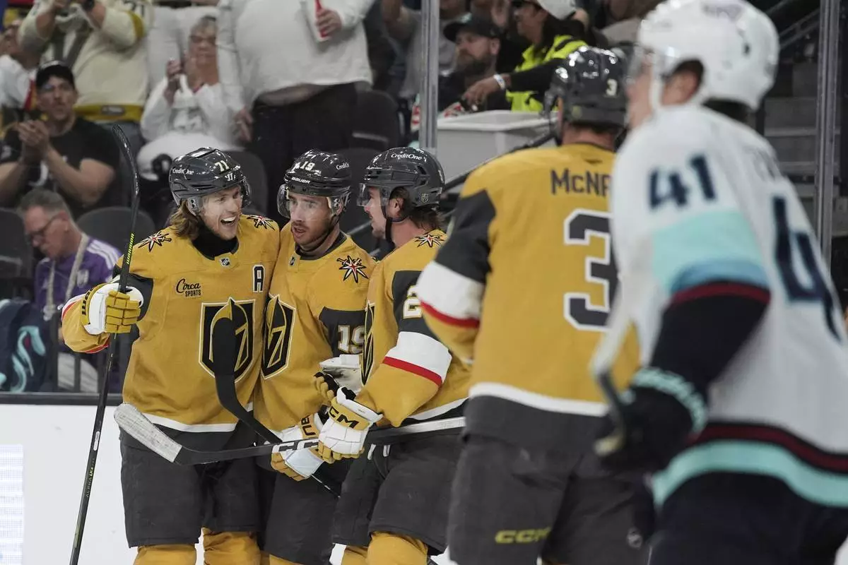 Vegas Golden Knights center William Karlsson, left, celebrates after scoring against the Seattle Kraken during the second period of an NHL hockey game Thursday, April 10, 2025, in Las Vegas. (AP Photo/John Locher)