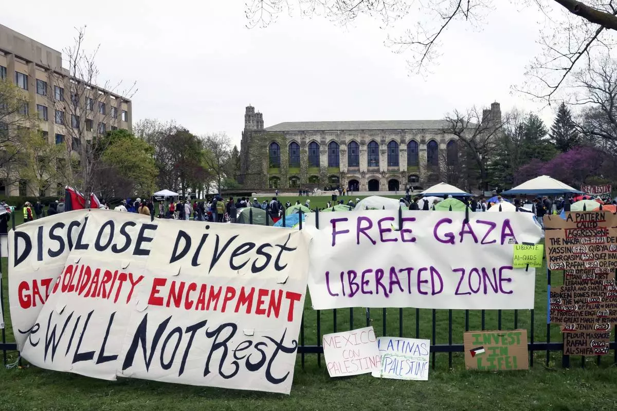 FILE - Signs are displayed outside a tent encampment at Northwestern University April 26, 2024, in Evanston, Ill. (AP Photo/Teresa Crawford, File)