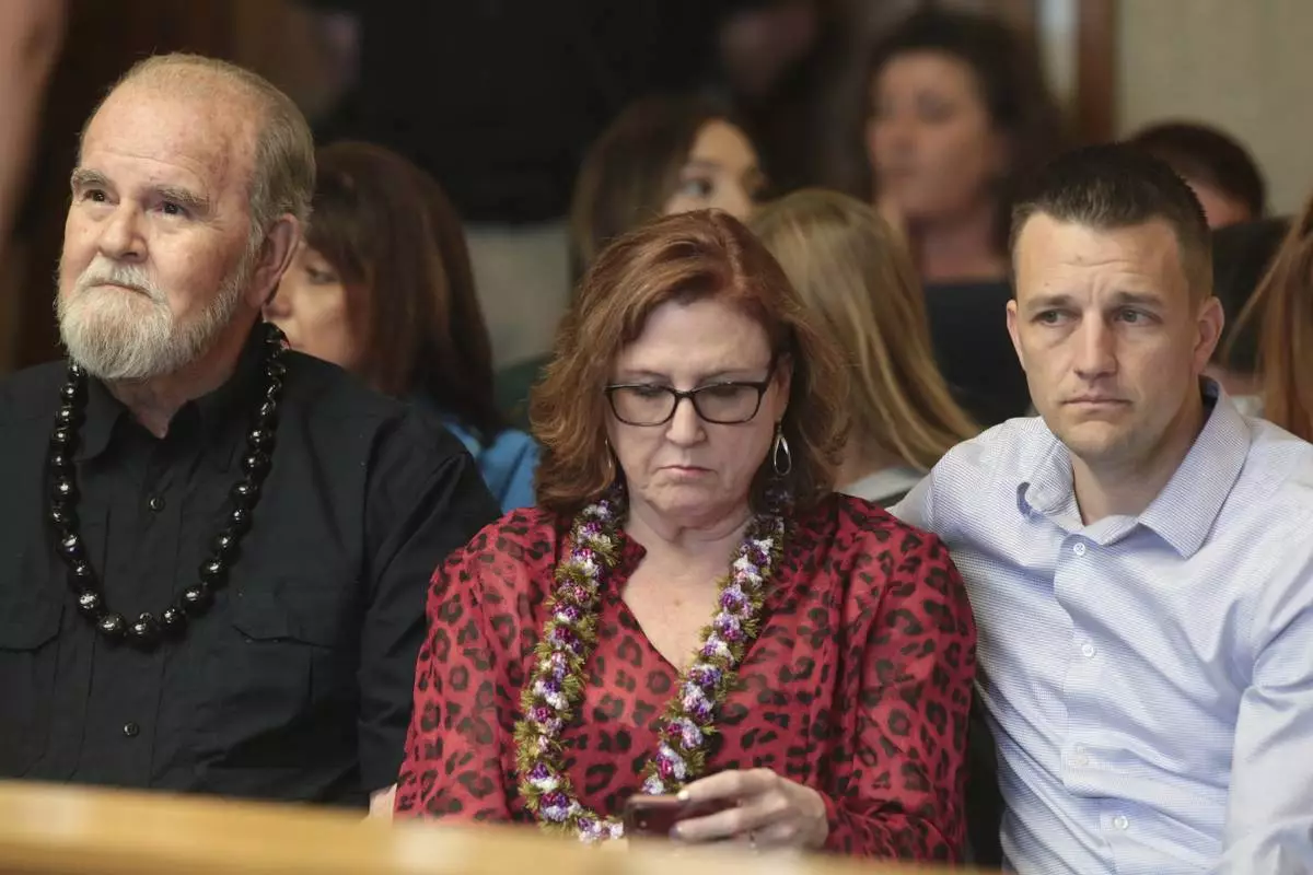 FILE - Larry Woodcock, from left, Kay Woodcock and Brandon Boudreaux attend the hearing for Lori Vallow Daybell on Friday, March 6, 2020, in Rexburg, Idaho. Daybell who is charged with felony child abandonment after her two children went missing nearly six months ago had her bond reduced to $1 million by an Idaho judge on Friday. (John Roark/The Idaho Post-Register via AP, Pool, File)