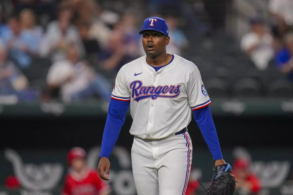 Texas Rangers starting pitcher Kumar Rocker heads to the dugout after pitching to the Los Angeles Angels during the seventh inning of a baseball game Thursday, April 17, 2025, in Arlington, Texas. (AP Photo/Julio Cortez)