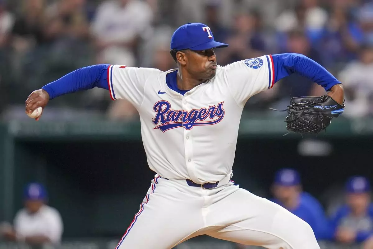 Texas Rangers starting pitcher Kumar Rocker throws a pitch to the Los Angeles Angels during the fifth inning of a baseball game Thursday, April 17, 2025, in Arlington, Texas. (AP Photo/Julio Cortez)