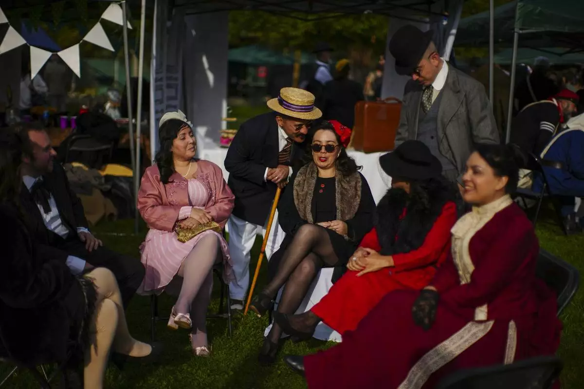 Participants gather for an Old Fashioned Fest at a park in Santiago, Chile, Saturday, April 5, 2025. (AP Photo/Esteban Felix)