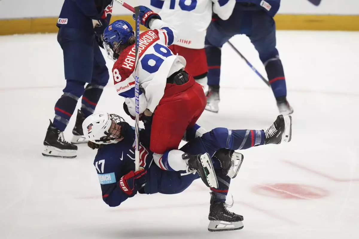 United States' Britta Curl, left, collides with Kristyna Kaltounkova of Czech Republic during the semi final match between Czech Republic and United States at the Women's Ice Hockey Championships in Ceske Budejovice, Czech Republic, Saturday, April 19, 2025. (AP Photo/Petr David Josek)