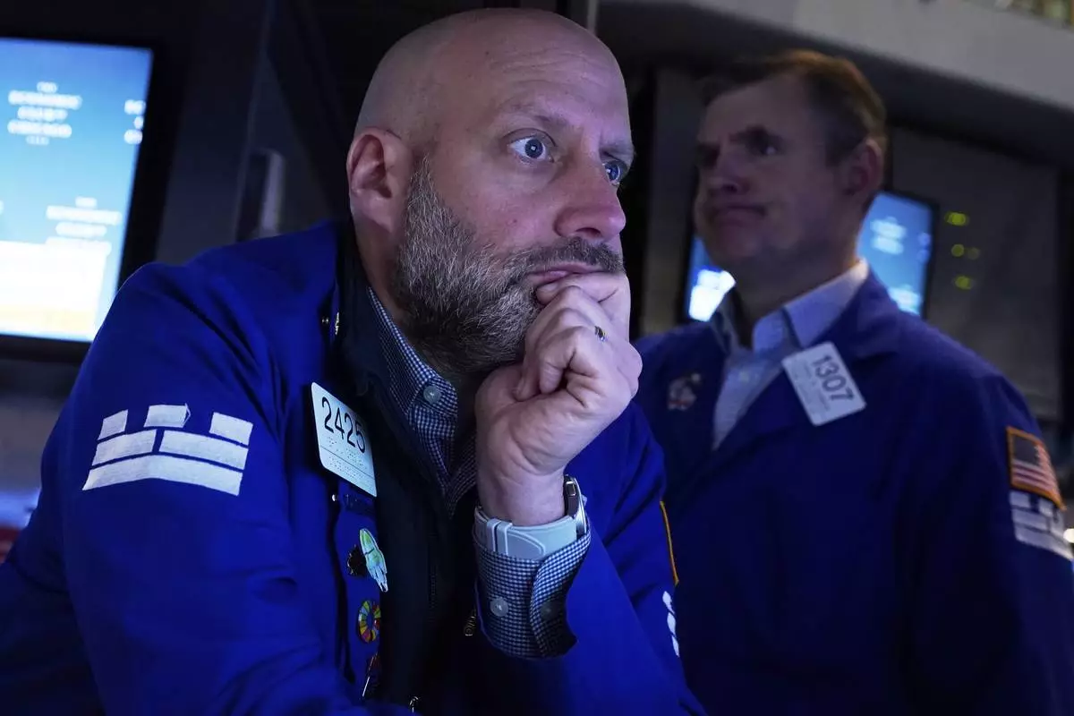 Specialist Meric Greenbaum, left, works at his post on the floor of the New York Stock Exchange, Thursday, April 17, 2025. (AP Photo/Richard Drew)