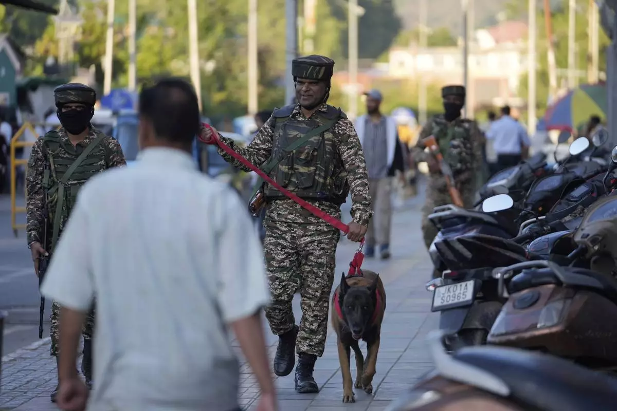 Indian paramilitary soldiers patrol as they guard at a busy market in Srinagar, Indian controlled Kashmir, Tuesday, April 29, 2025. (AP Photo/Mukhtar Khan)