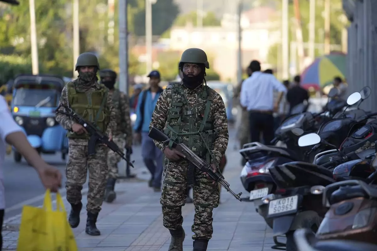 Indian paramilitary soldiers patrol as they guard at a busy market in Srinagar, Indian controlled Kashmir, Tuesday, April 29, 2025. (AP Photo/Mukhtar Khan)