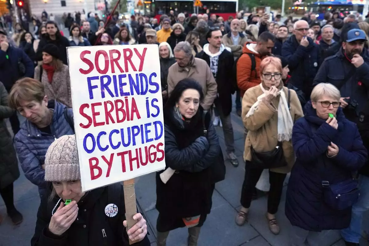 People protest the government's expulsion and entry bans on foreign citizens, for alleged security risks to the Balkan country, in Belgrade, Serbia, Thursday, April 10, 2025. (AP Photo/Darko Vojinovic)
