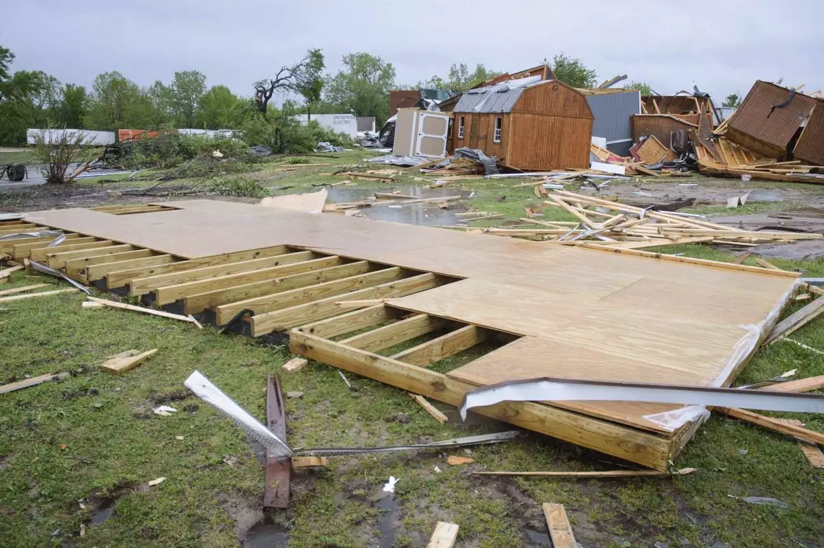 Broken sheds, lumber, and walls lie strewn on the ground behind Quality Inn, Sunday, April 20, 2025 in Ada, Okla. (Richard R. Barron/The ADA News via AP)