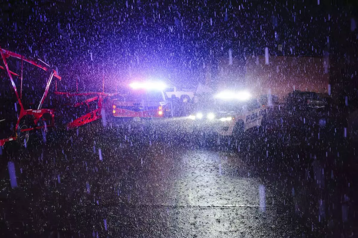 Rain falls as police vehicles block a road in Ada, Okla. Saturday, April 19, 2025. (Richard R. Barron /The ADA News via AP)