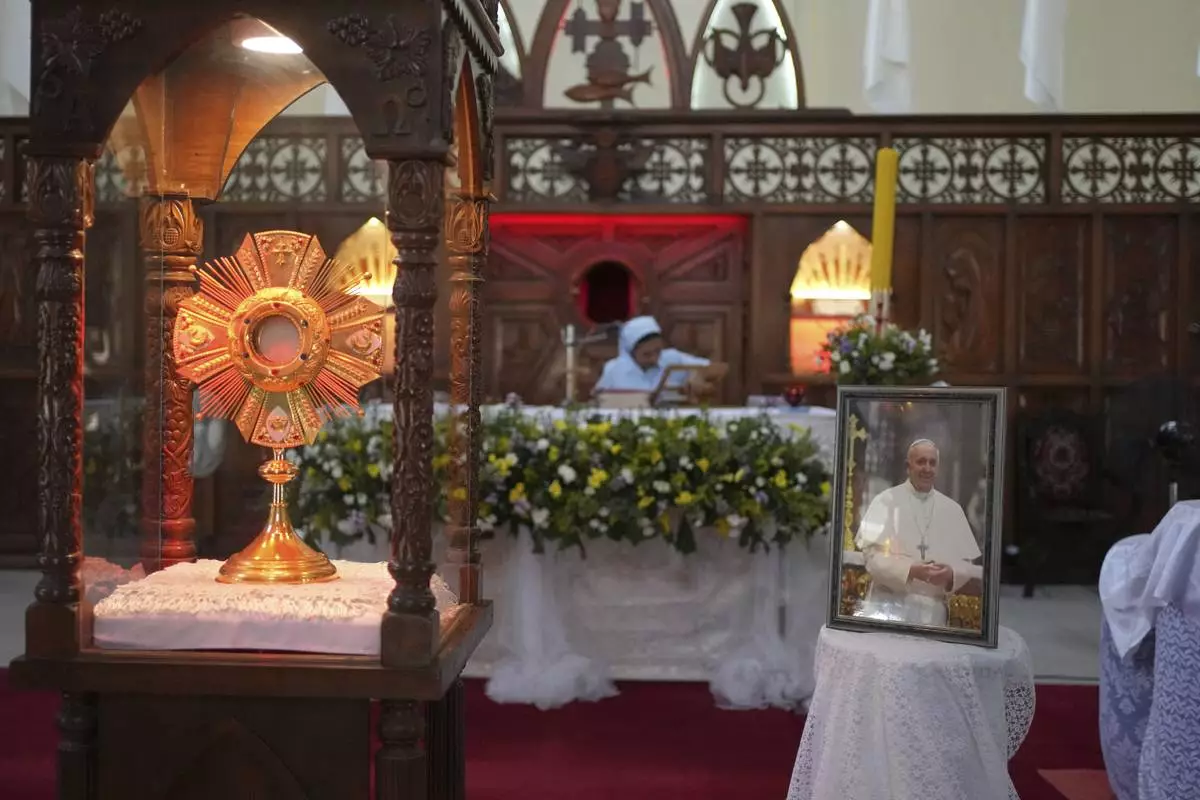 A portrait of Pope Francis is displayed in reverence at a church in Colombo, Sri Lanka, Tuesday, April 22, 2025. (AP Photo/Eranga Jayawardena)