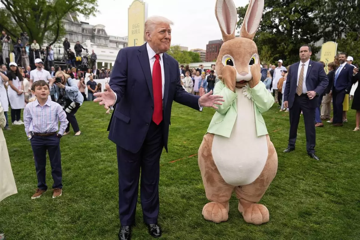 President Donald Trump stands with the Easter bunny as he participates in the White House Easter Egg Roll on the South Lawn of the White House, Monday, April 21, 2025, in Washington. (AP Photo/Mark Schiefelbein)