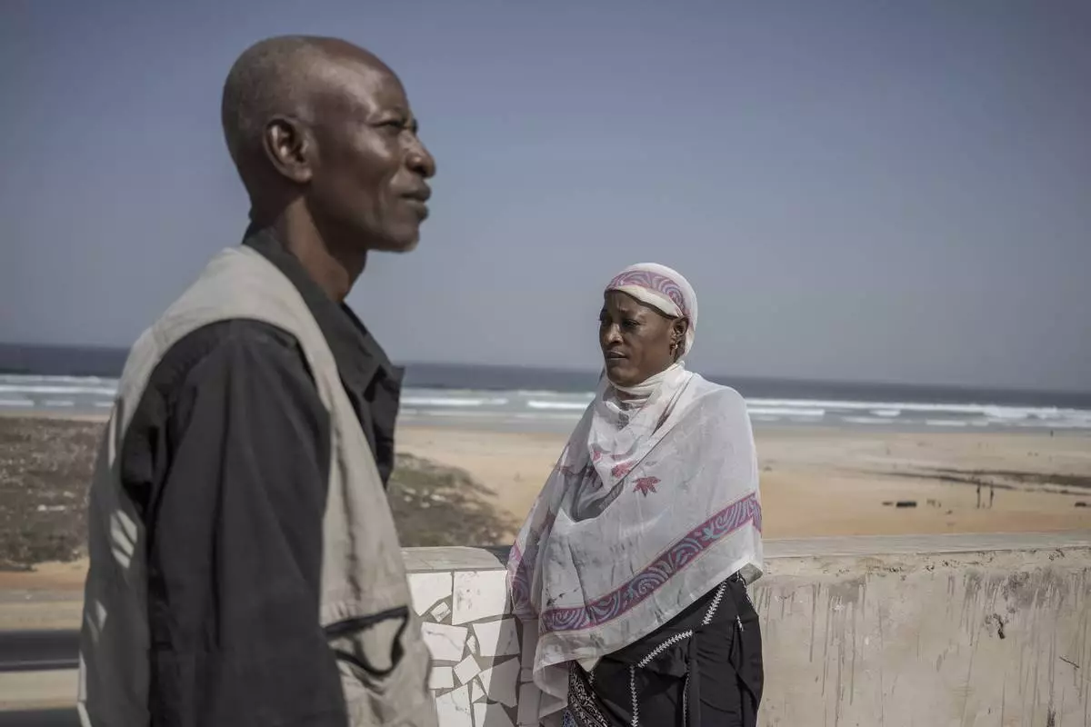 Pathe Gueye, left, and Ndeye Lam, right, stand on their roof in Dakar, Senegal Saturday, Jan. 11, 2025. Their daughter Mariama died at age 13 of a rare genetic disease. (AP Photo/Annika Hammerschlag)