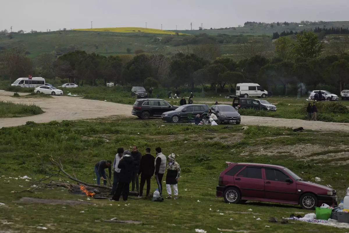 People gather outdoors away from urban areas following an earthquake shock with a preliminary magnitude of 6.2, in Istanbul, Turkey, Wednesday, April 23, 2025. (AP Photo/Khalil Hamra)