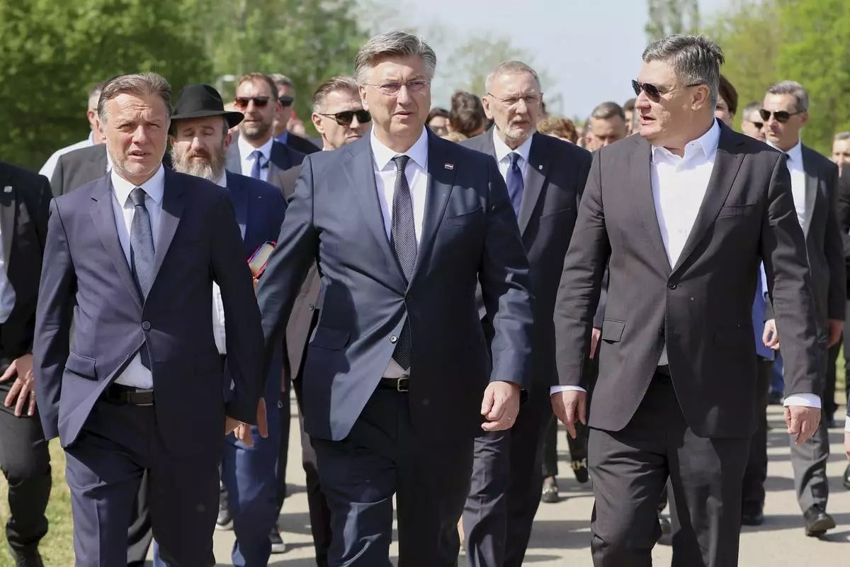 From left, Croatian Parliament Speaker Goran Jandrokovic, Prime Minister Andrej Plenkovic and President Zoran Milanovic walk towards the monument commemorating victims of a World War II concentration camp, where tens of thousands of people perished in the hands of the pro-Nazi puppet regime at the time, in Jasenovac, Croatia, Tuesday, April 22, 2025. (AP Photo)
