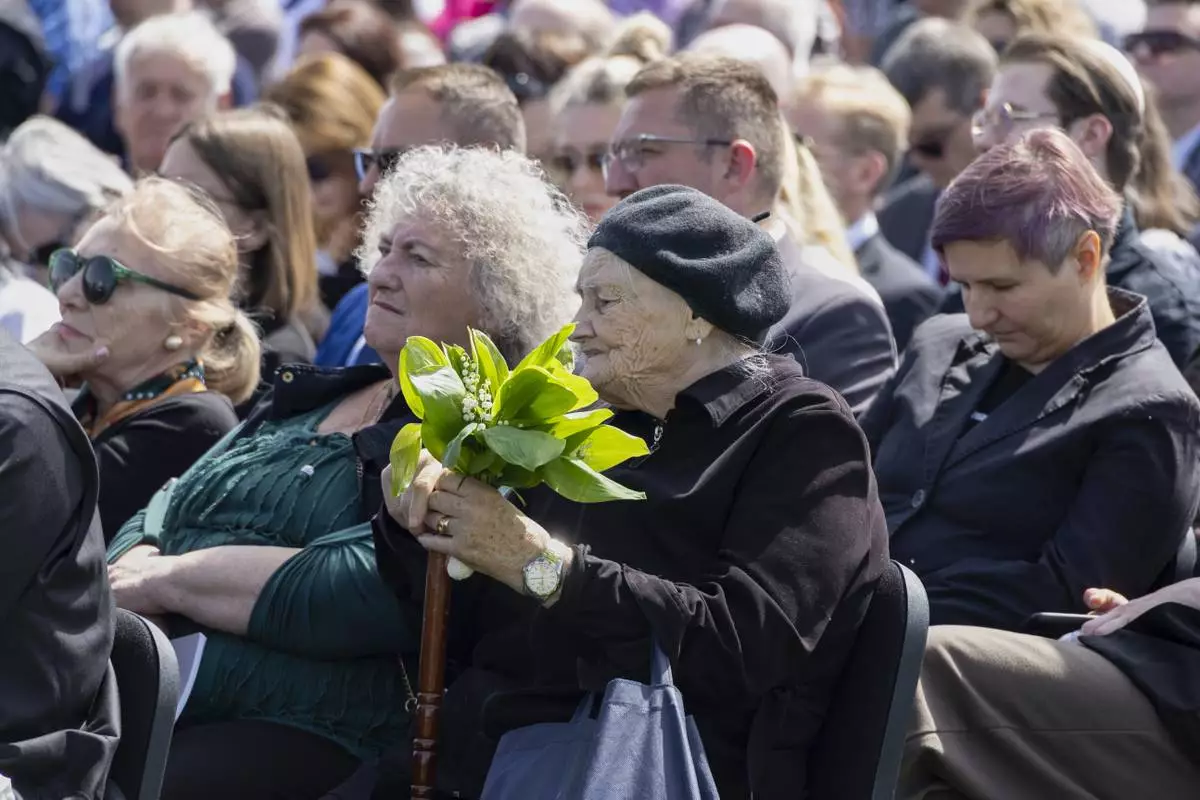People gather commemorating victims of a World War II concentration camp, where tens of thousands of people perished in the hands of the pro-Nazi puppet regime at the time, in Jasenovac, Croatia, Tuesday, April 22, 2025. (AP Photo)