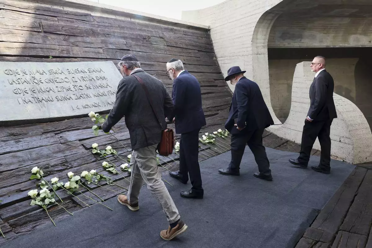 Representatives of the Jewish community lay flowers at the monument commemorating victims of a World War II concentration camp, where tens of thousands of people perished in the hands of the pro-Nazi puppet regime at the time, in Jasenovac, Croatia, Tuesday, April 22, 2025. (AP Photo)
