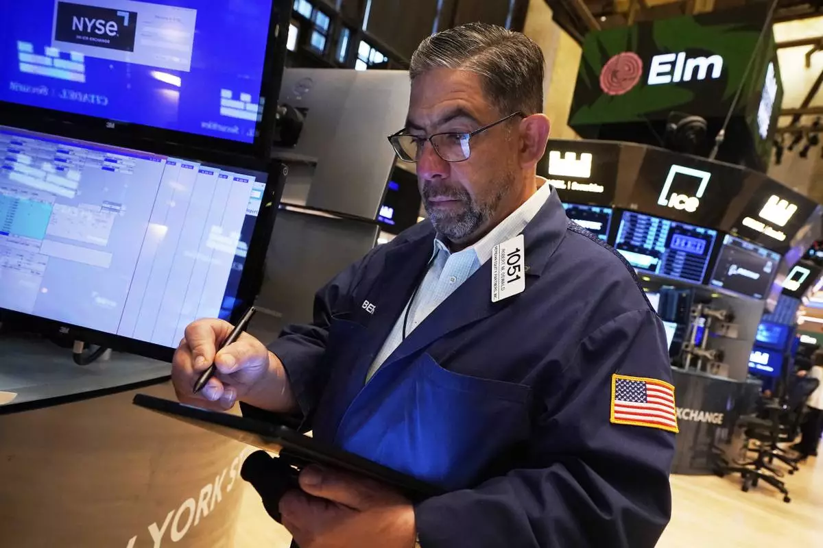 Trader Robert Oswald works on the floor of the New York Stock Exchange, Wednesday, April 23, 2025. (AP Photo/Richard Drew)