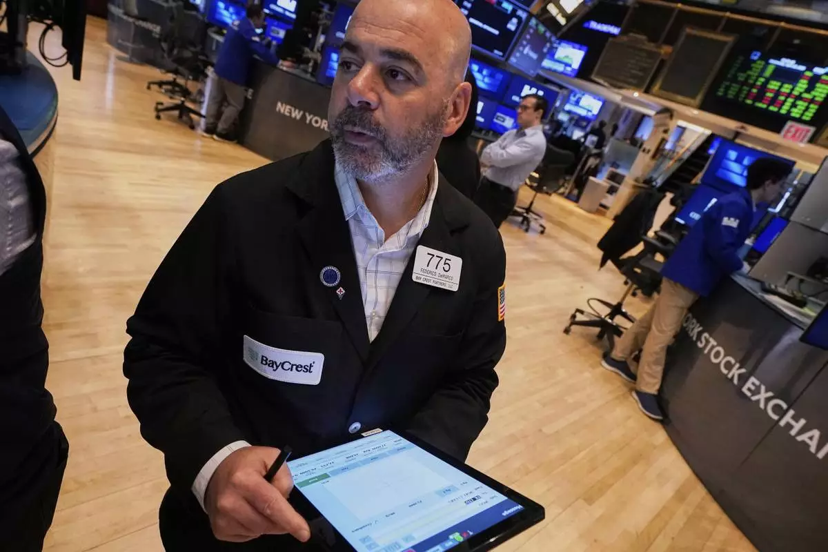 Trader Fred Demarco works on the floor of the New York Stock Exchange, Wednesday, April 23, 2025. (AP Photo/Richard Drew)