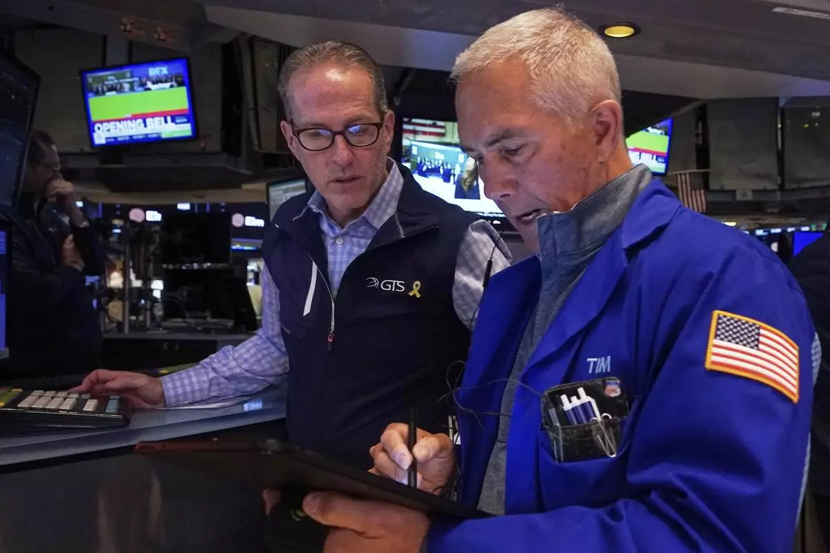 Specialist Glenn Carell, left, and trader Timothy Nick work on the floor of the New York Stock Exchange, Wednesday, April 23, 2025. (AP Photo/Richard Drew)