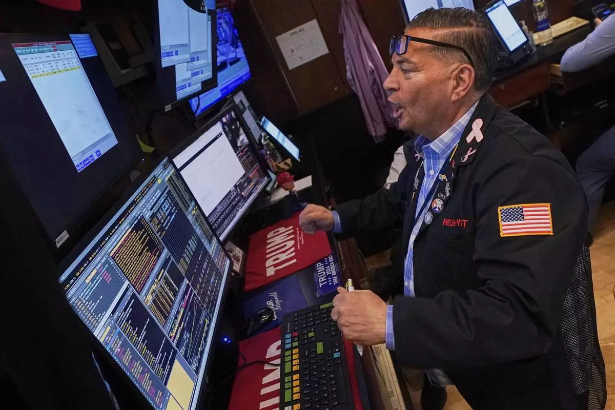 Trader Jonathan Mueller works on the floor of the New York Stock Exchange, Wednesday, April 23, 2025. (AP Photo/Richard Drew)