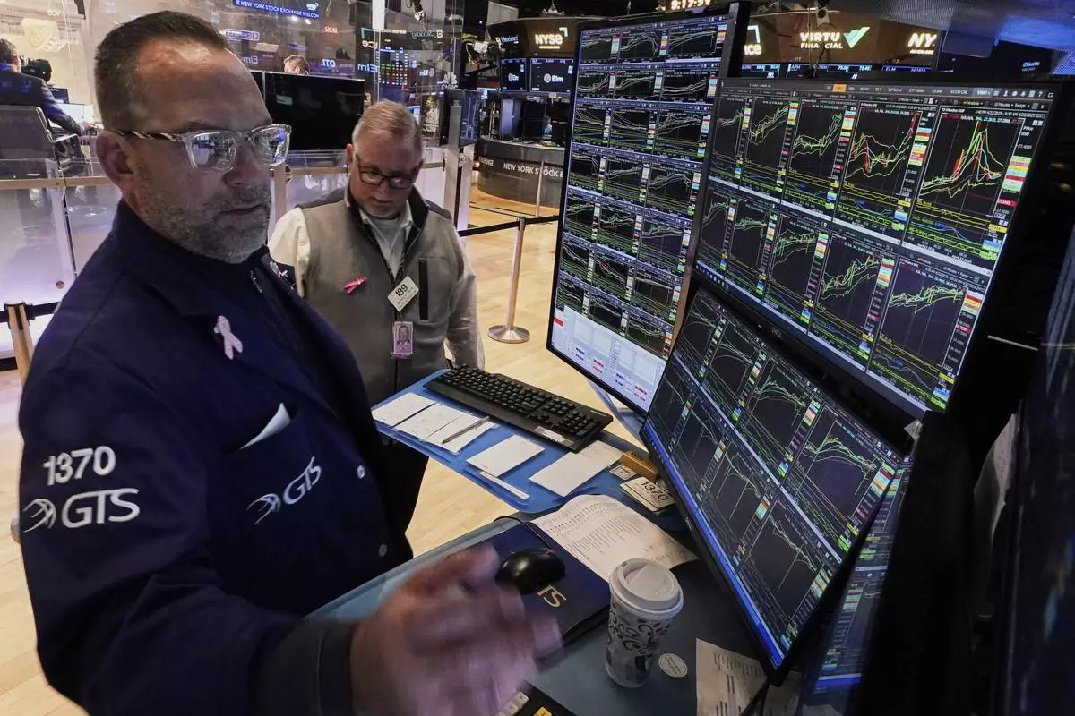 Specialist Anthony Matesic, left, and trader Michael Conlon work on the floor of the New York Stock Exchange, Wednesday, April 23, 2025. (AP Photo/Richard Drew)