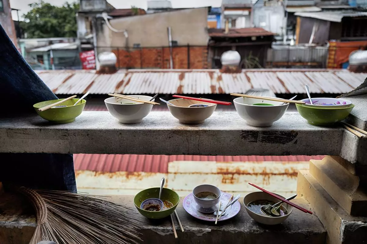 Finished breakfast bowls of pho, a Vietnamese soup, sit on a ledge in the Cholon district of Ho Chi Minh City, Vietnam, Tuesday, April 29, 2025, ahead of the 50th anniversary of the end of the Vietnamese War. (AP Photo/Richard Vogel)