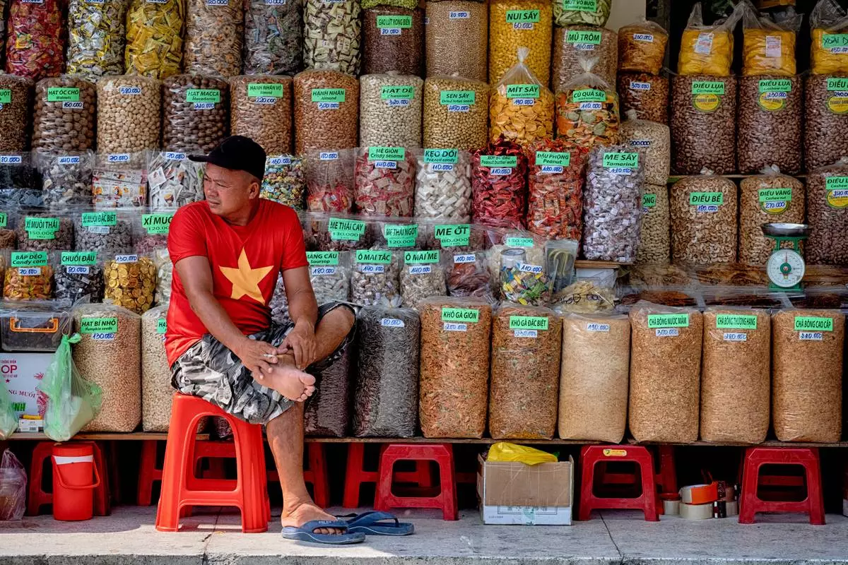 A spice vendor waits for customers at the Cholon market in the Cholon district of Ho Chi Minh City, Vietnam, on Tuesday, April 29, 2025 ahead of the 50th anniversary of the end of the Vietnamese War. (AP Photo/Richard Vogel)