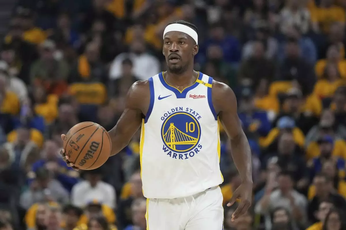 Golden State Warriors forward Jimmy Butler III brings the ball up the court against the Memphis Grizzlies during the first half of an NBA play-in tournament basketball game in San Francisco, Tuesday, April 15, 2025. (AP Photo/Jeff Chiu)