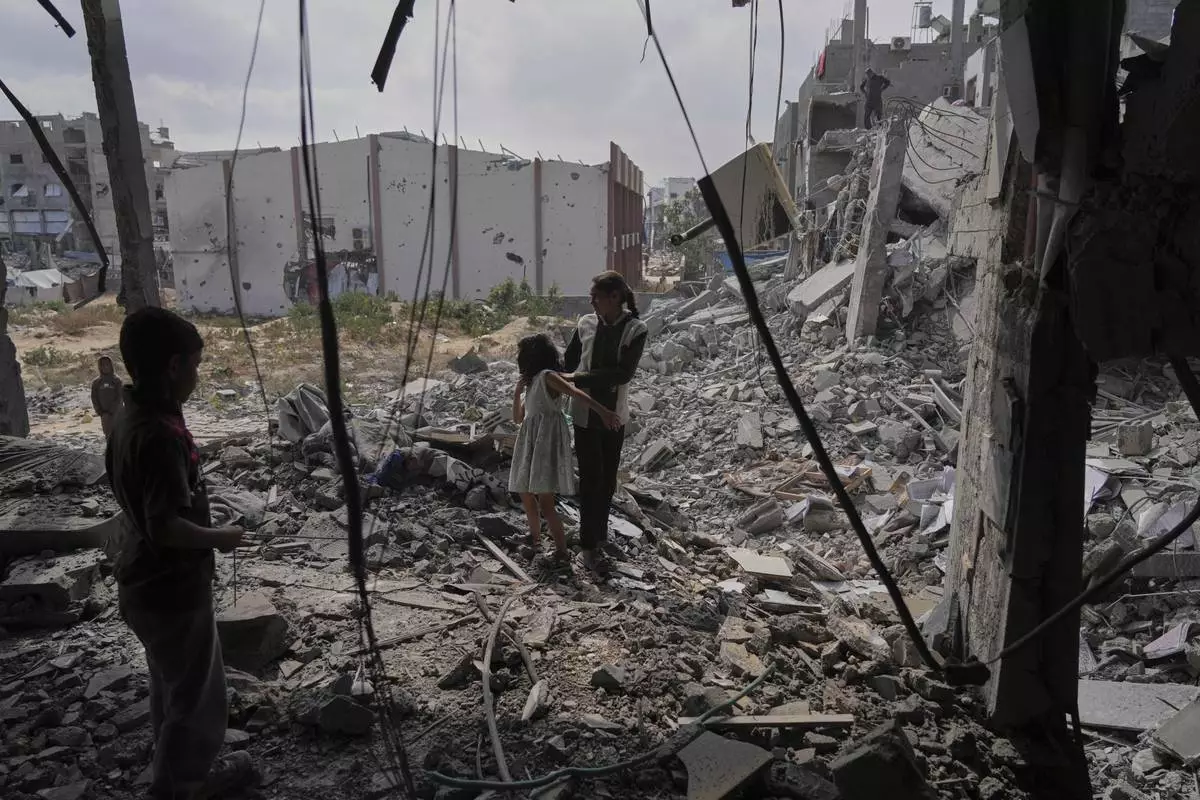 Palestinians look at the damage after an Israeli army airstrike in Beit Lahia, northern Gaza Strip, Monday, April 28, 2025. (AP Photo/Jehad Alshrafi)