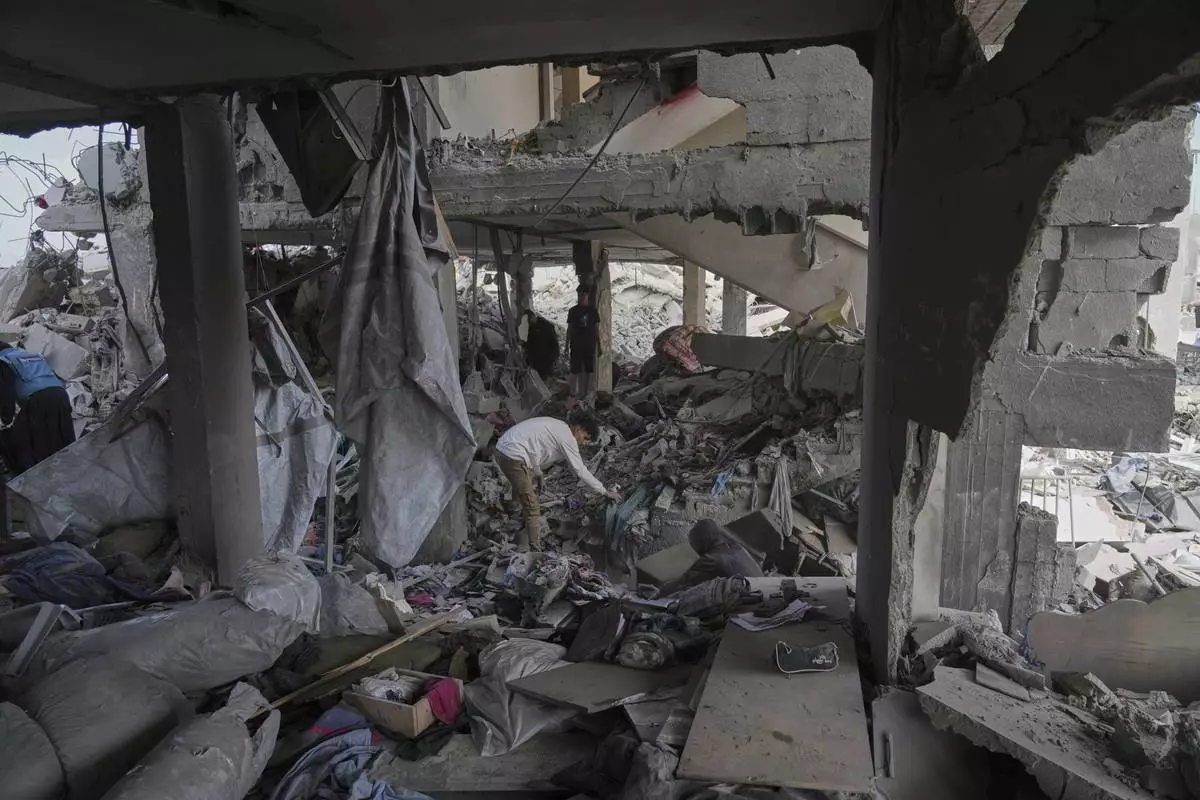 Palestinians look at the damage after an Israeli army airstrike in Beit Lahia, northern Gaza Strip, Monday, April 28, 2025. (AP Photo/Jehad Alshrafi)