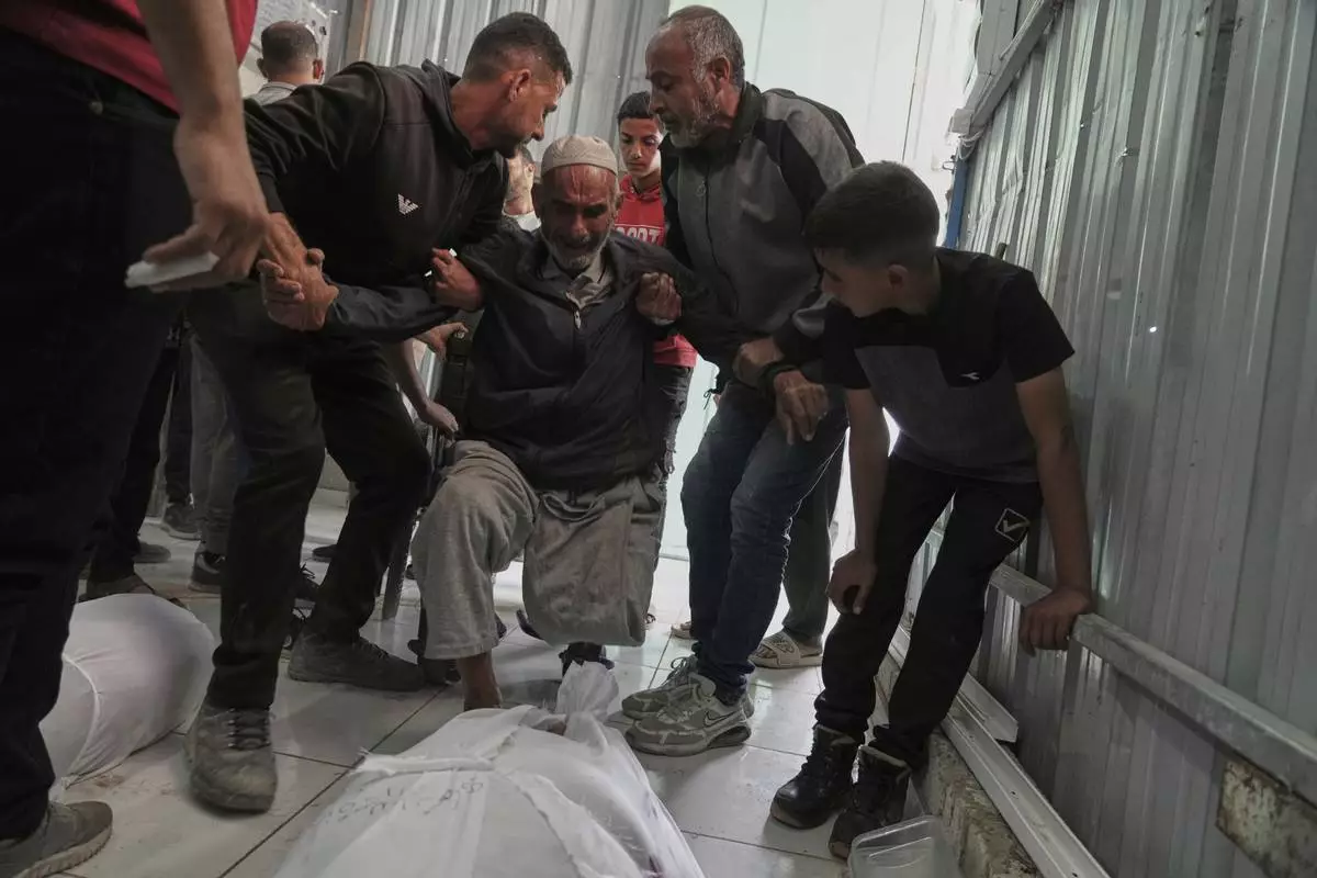 Relatives mourn over the bodies of several members of the Abu Mahdi family, killed in an Israeli army airstrike, during their funeral at the Indonesian hospital in Beit Lahia, northern Gaza Strip, Monday, April 28, 2025. (AP Photo/Jehad Alshrafi)