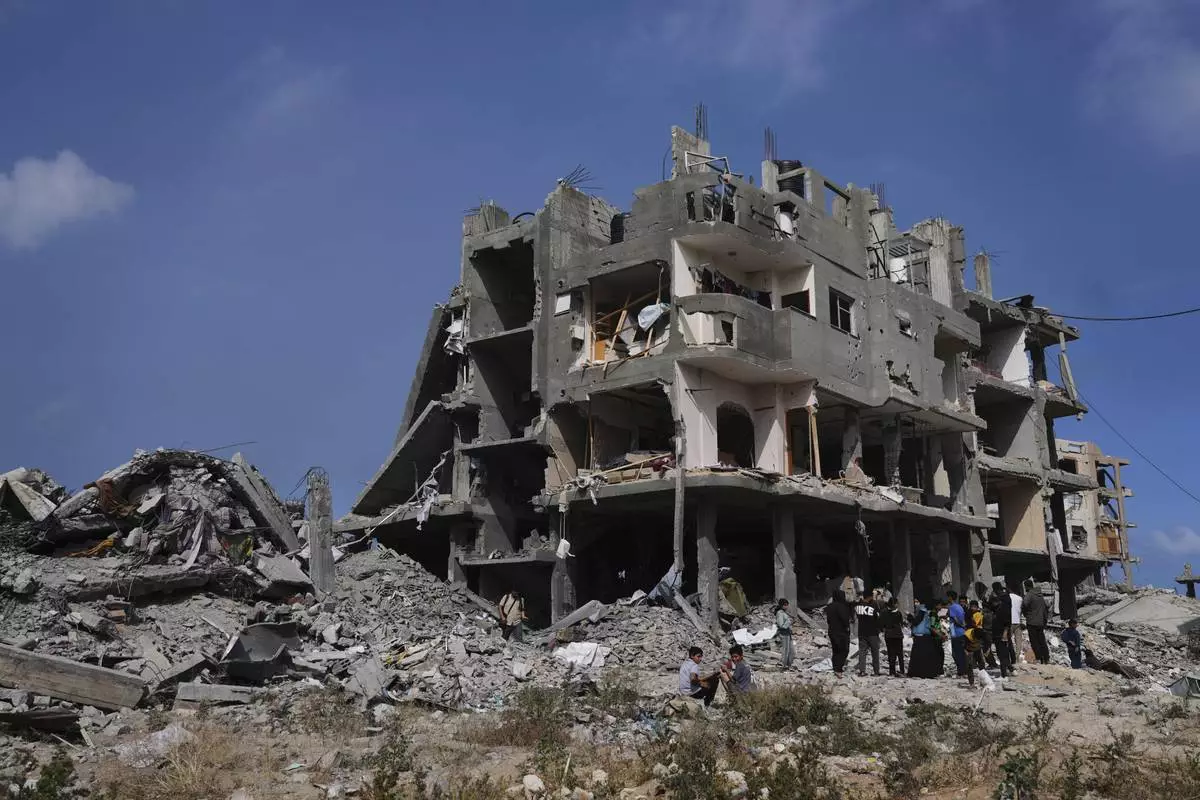Palestinians look at the damage after an Israeli army airstrike in Beit Lahia, northern Gaza Strip, Monday, April 28, 2025. (AP Photo/Jehad Alshrafi)