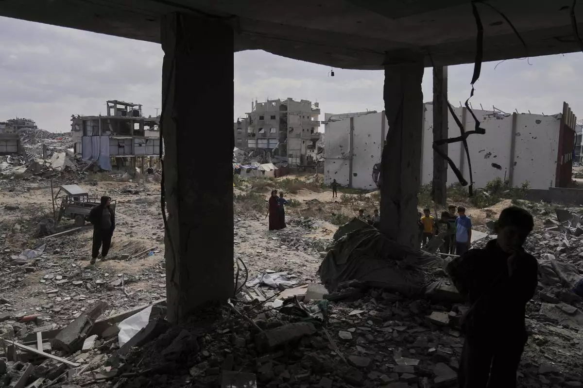 Palestinians look at the damage after an Israeli army airstrike in Beit Lahia, northern Gaza Strip, Monday, April 28, 2025. (AP Photo/Jehad Alshrafi)