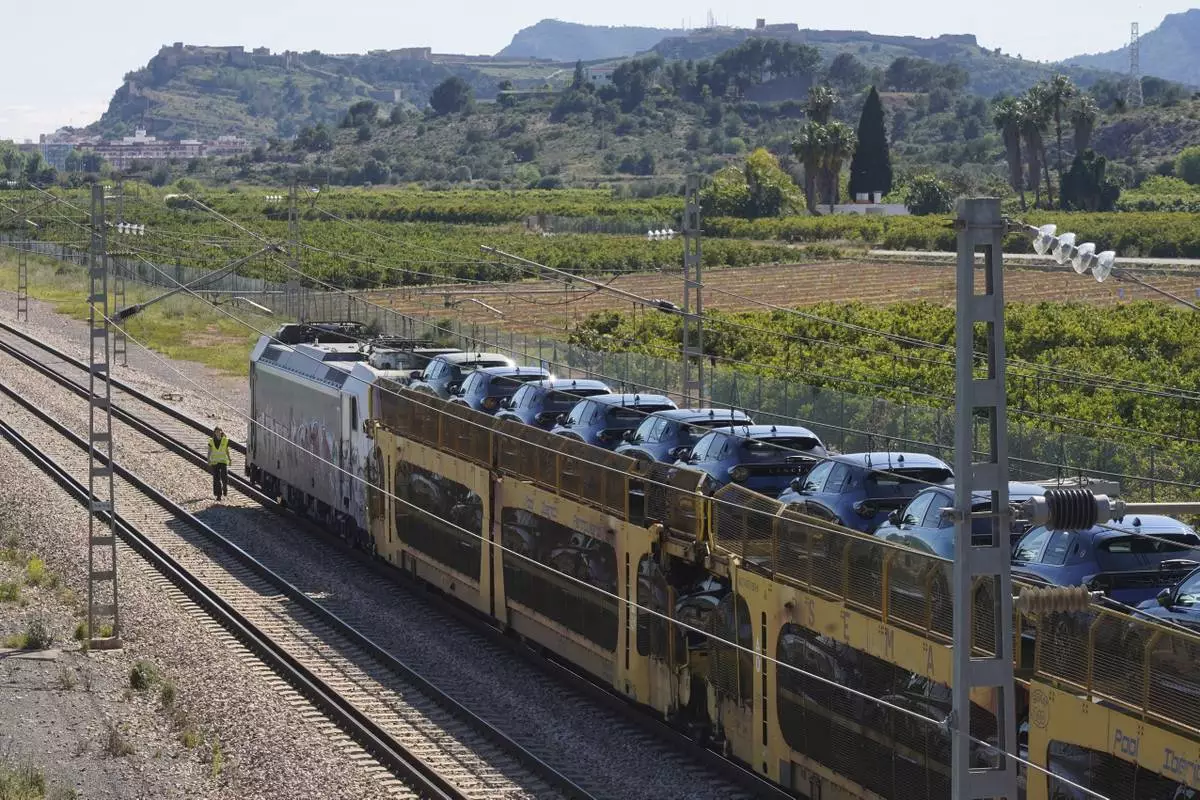 A freight train loaded with cars is stopped on the track during a nationwide power outage near Sagunto, eastern Spain, Monday, April 28, 2025. (AP Photo/Alberto Saiz)