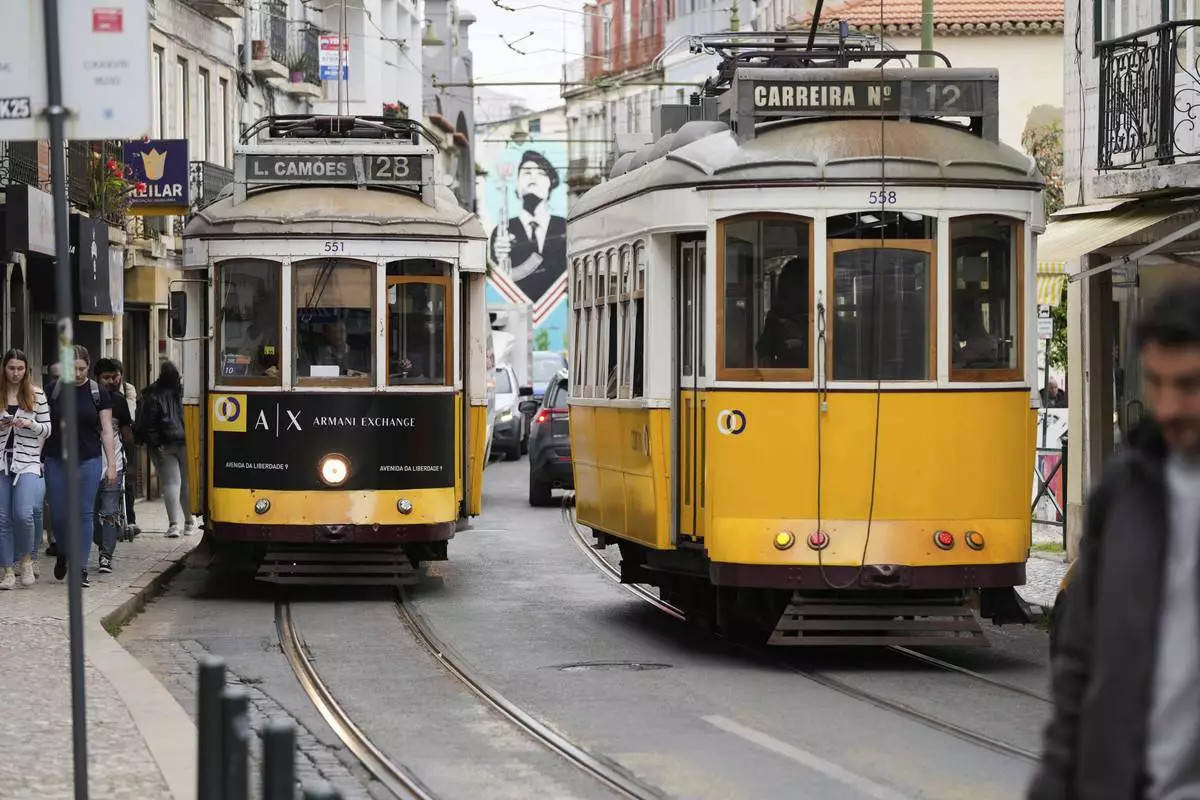 Electric trams drive through Lisbon, Tuesday, April 29, 2025, the day after a nationwide power outage that stopped trams, trains and subways. (AP Photo/Armando Franca)