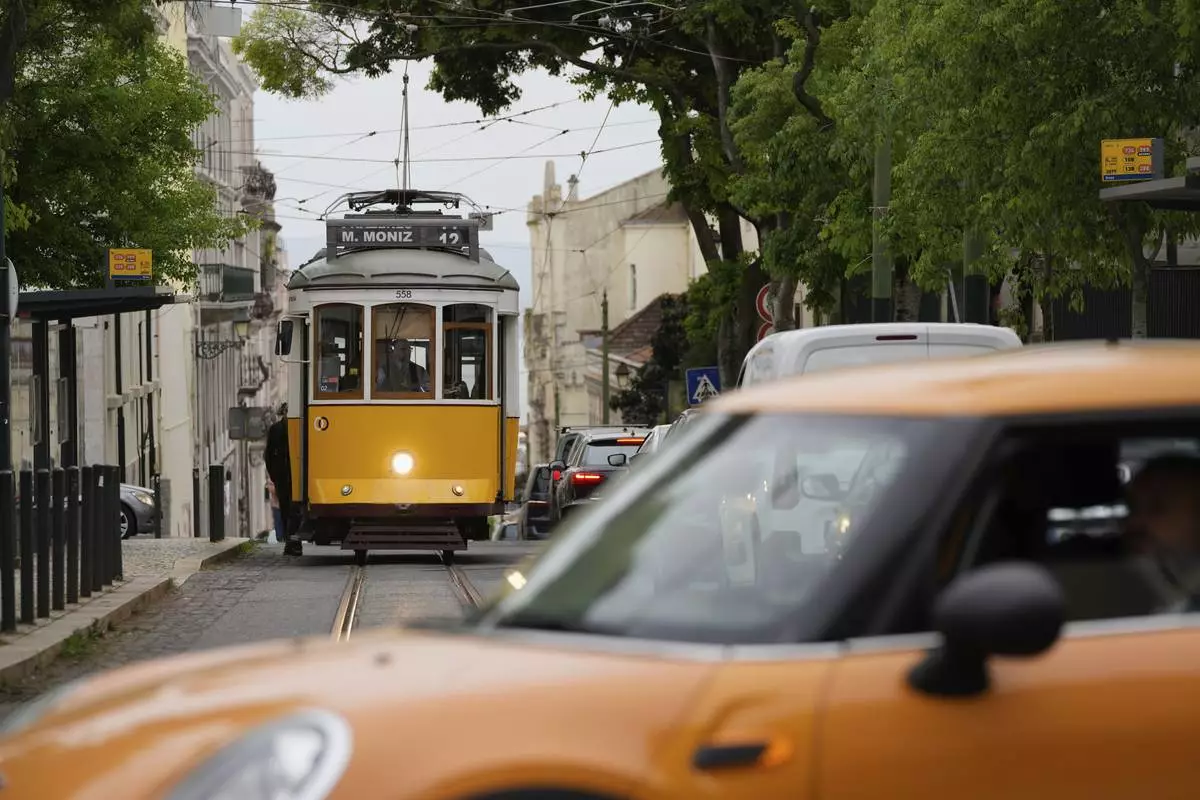 An electric tram drives uphill in Lisbon, Tuesday, April 29, 2025, the day after a nationwide power outage that stopped trams, trains and subways. (AP Photo/Armando Franca)