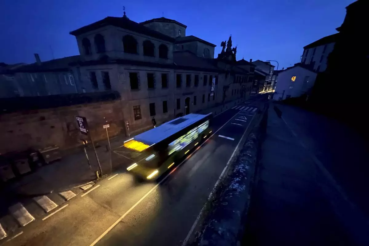 A city bus goes by the historic city of Santiago, Spain during a major power outage across Spain and Portugal Monday, April, 28, 2025. (AP Photo/Mic Smith)