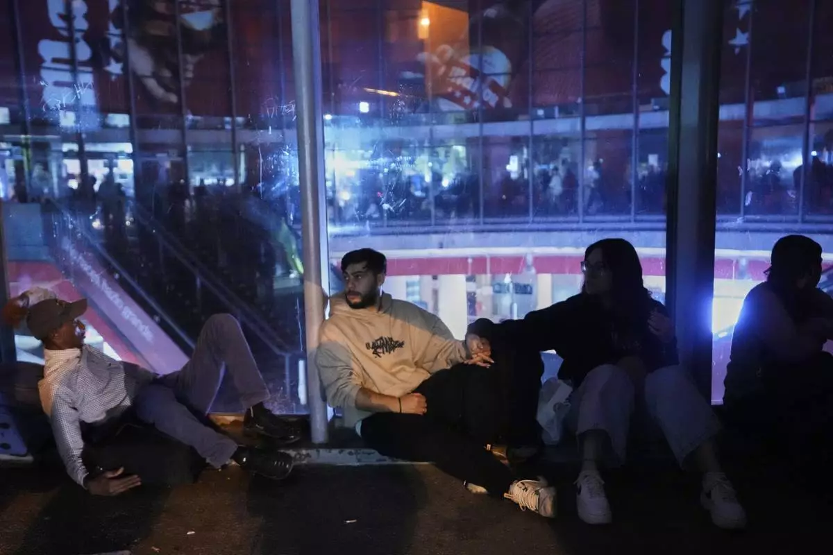 People gather in Atocha train station during a major power outage in Madrid, Monday, April 28, 2025. (AP Photo/Manu Fernandez)