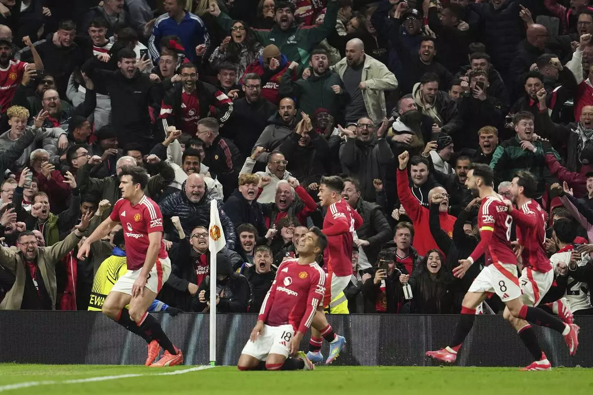 Manchester United's Harry Maguire, left, celebrates with team mates after his side's fifth goal during the Europa League quarter final second leg soccer match between Manchester United and Olympique Lyon in Manchester, Britain, Thursday, April 17, 2025. (AP Photo/Jon Super)