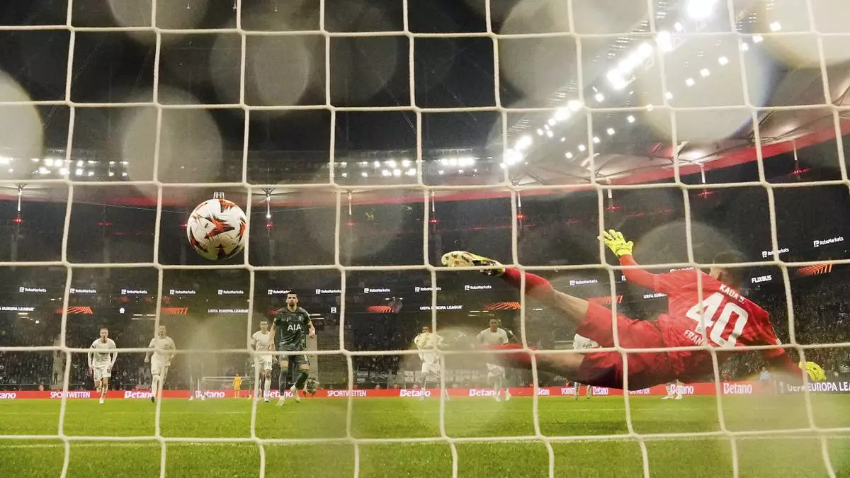 Tottenham's Dominic Solanke scores the opening goal from the penalty spot against Frankfurt's goalkeeper Kaua Santos during the Europa League quarterfinal second leg soccer match between Eintracht Frankfurt and Tottenham Hotspur, in Frankfurt, Germany, Thursday, April 17, 2025. (AP Photo/Martin Meissner)