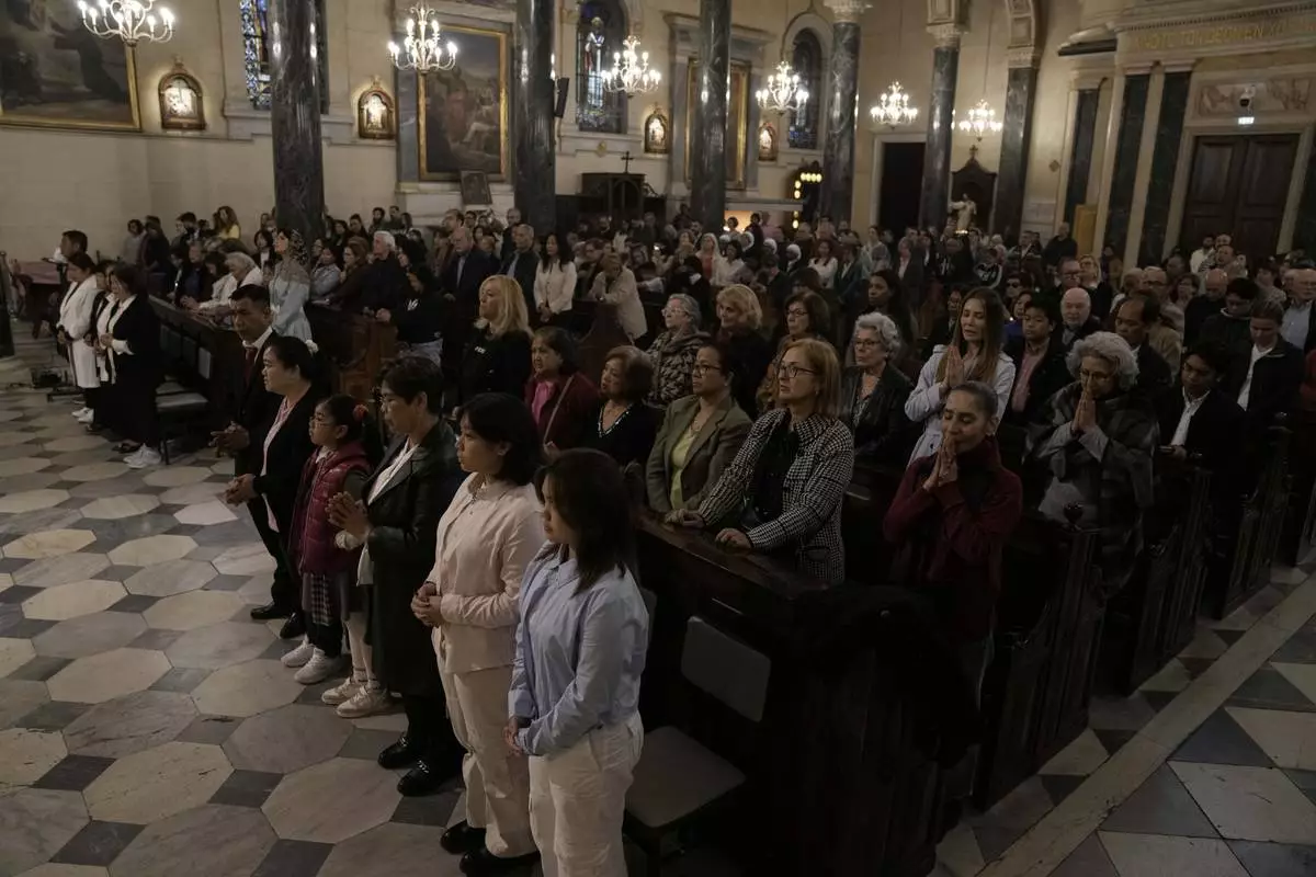 Greek Catholic believers and foreigners who live in Greece attend the mass of last supper at the Catholic Cathedral Basilica of St Dionysius the Areopagite in Athens, Greece, Holy Thursday, April 17, 2025. (AP Photo/Thanassis Stavrakis)