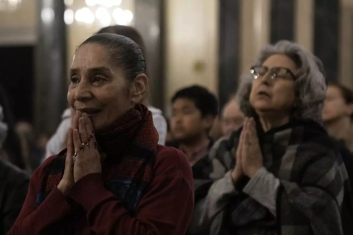 Greek Catholic believers and foreigners who live in Greece attend the mass of last supper at the Catholic Cathedral Basilica of St Dionysius the Areopagite in Athens, Greece, Holy Thursday, April 17, 2025. (AP Photo/Thanassis Stavrakis)