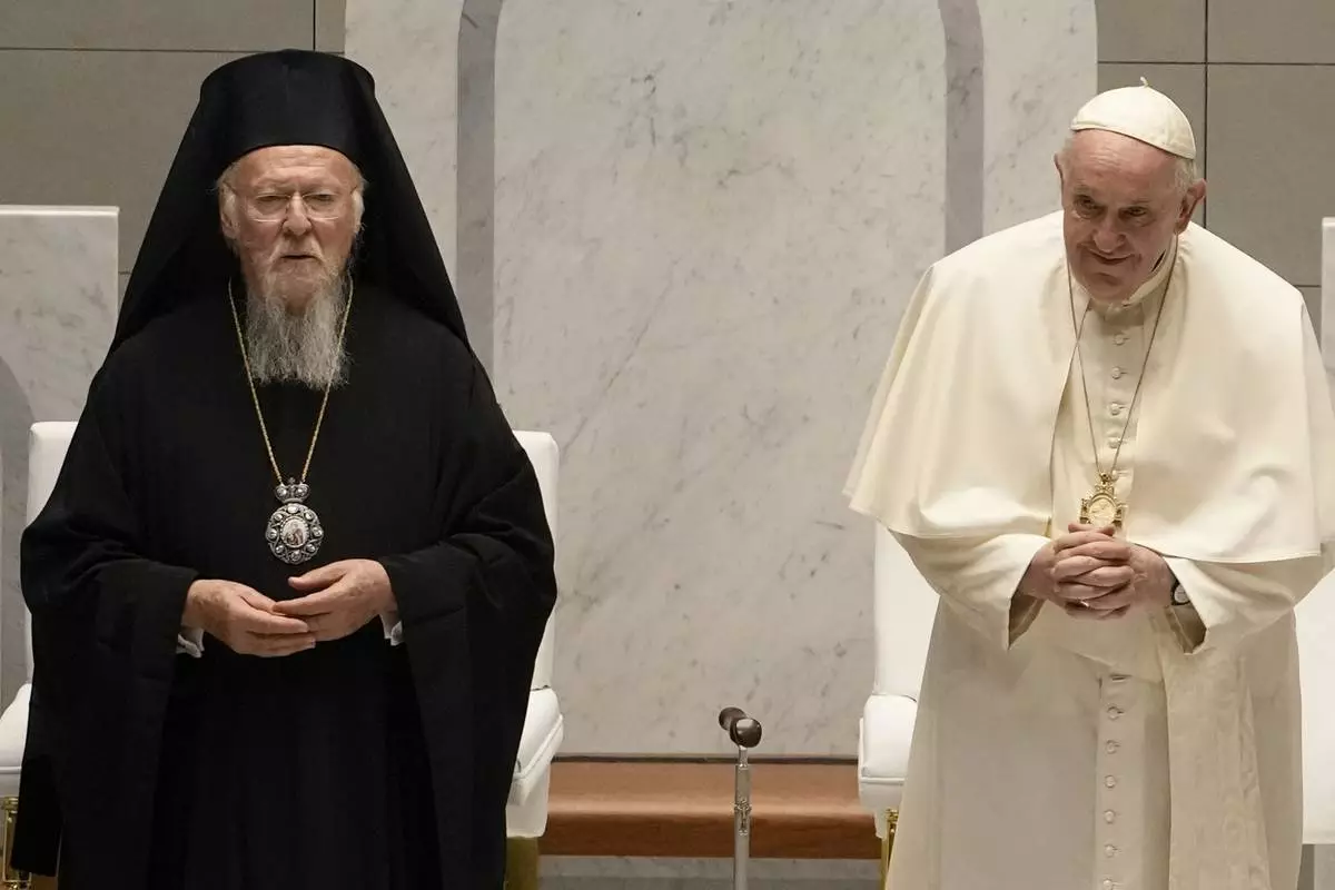 FILE - Pope Francis and Ecumenical Patriarch Bartholomew attend an ecumenical meeting and prayer for peace in Our Lady of Arabia Cathedral, Sakhir, Bahrain, Friday, Nov. 4, 2022. (AP Photo/Alessandra Tarantino, File)