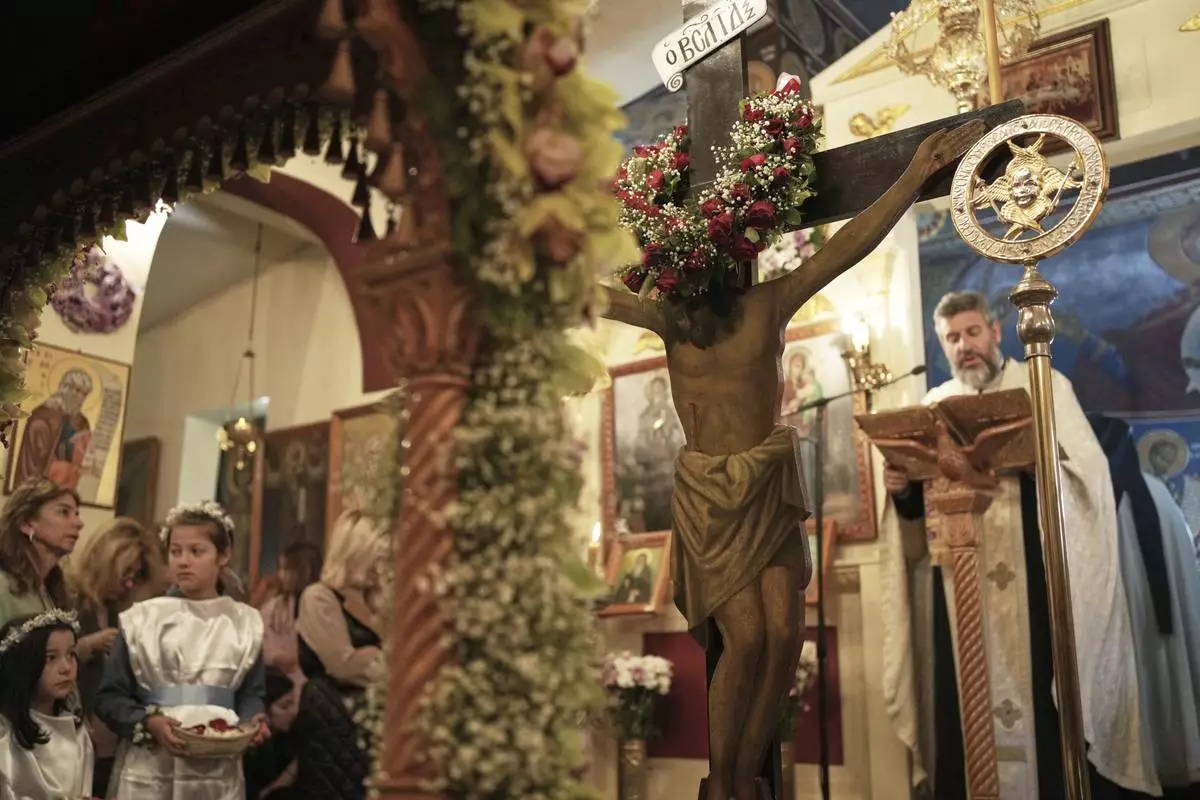 Believers attend the Good Friday reenactment of Deposition of Jesus Christ, at Agios Antonios church in the northern suburb of Chalandri, in Athens, Greece, Friday, April 18, 2025. (AP Photo/Thanassis Stavrakis)
