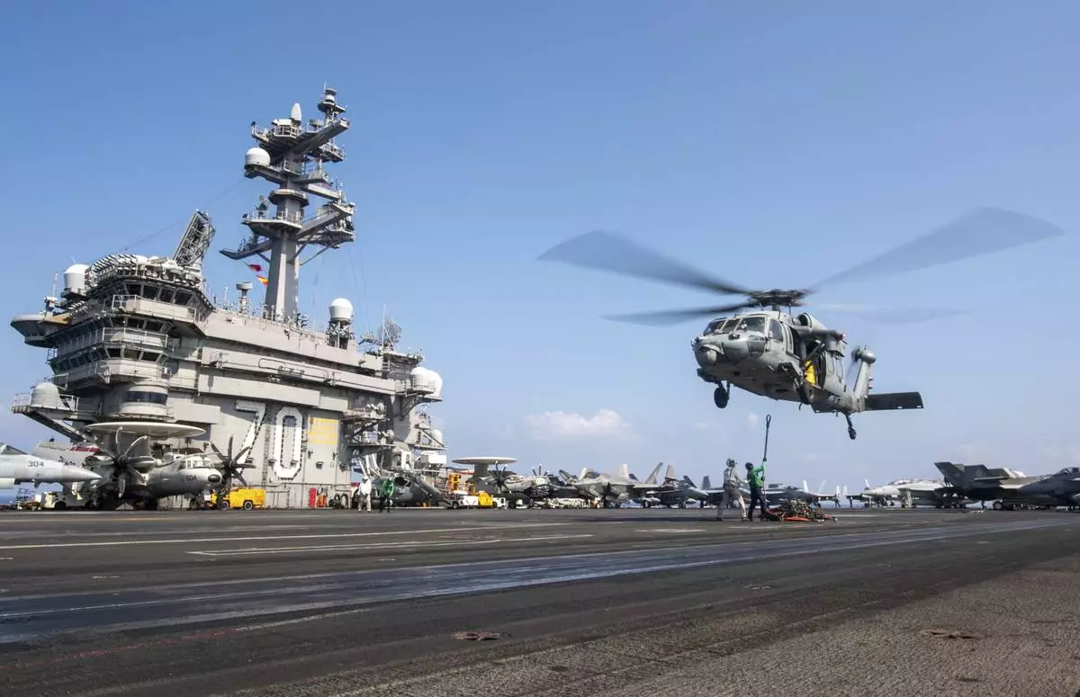 This photograph released by the U.S. Navy shows a MH-60S Sea Hawk helicopter hovering over the USS Carl Vinson aircraft carrier while operating in the Middle East on April 12, 2025. (Petty Officer 3rd Class Nathan Jordan/U.S. Navy via AP)