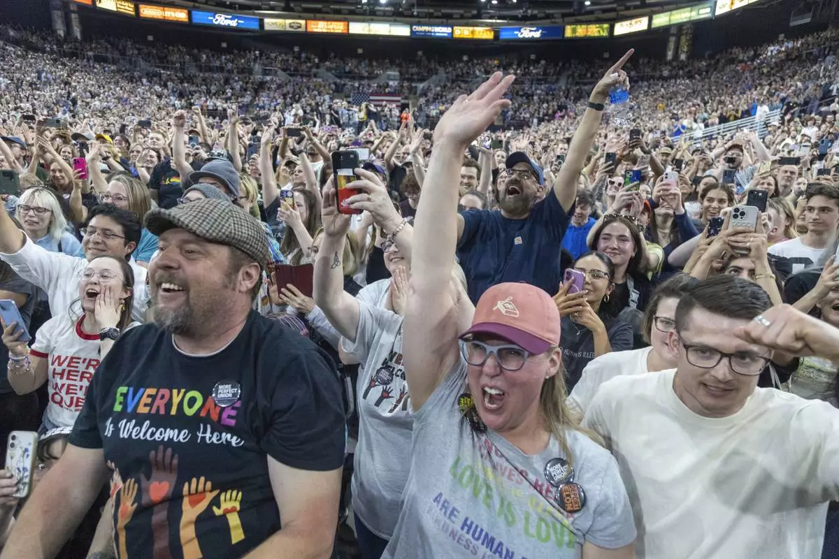 Attendees cheer as Rep. Alexandra Ocasio-Cortez, D-N.Y., speaks during a "Fighting Oligarchy" event at the Ford Idaho Center in Nampa, Idaho, Monday, April 14, 2025. (AP Photo/Kyle Green)