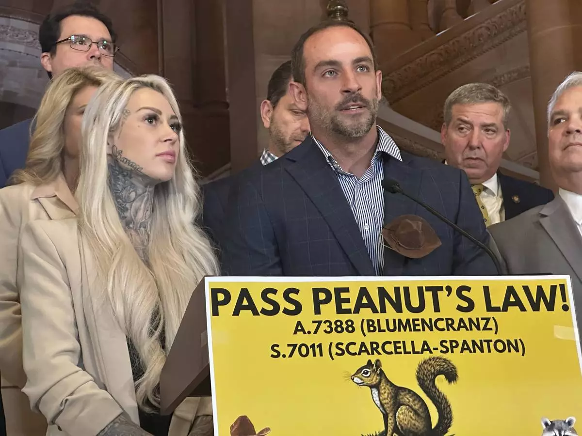 Mark Longo, center, and his wife Daniela Bittner, left, speak during a news conference at the state capitol building, Tuesday, April 8, 2025, in Albany, N.Y. (AP Photo/Michael Hill)